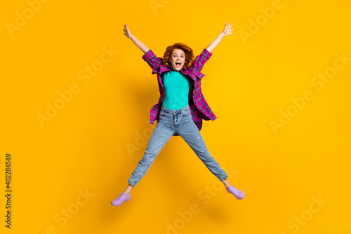 Full length portrait of attractive playful lady jumping star figure wear magenta outfit isolated on yellow color background