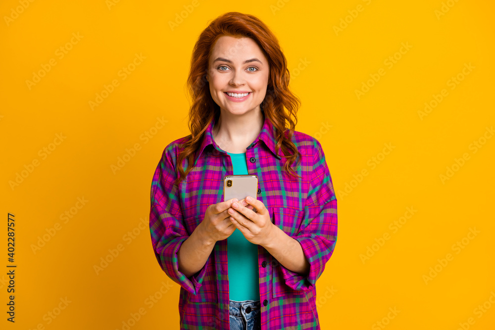 Portrait of curly hairstyle charming lady wear checkered purple clothing isolated on yellow color background Portrait of curly hairstyle charming lady wear checkered purple clothing isolated on yellow color background