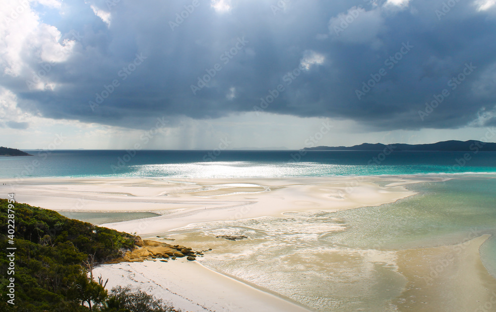 Whitsundays stormy weather over beautiful beach Whitsundays stormy weather over beautiful beach
