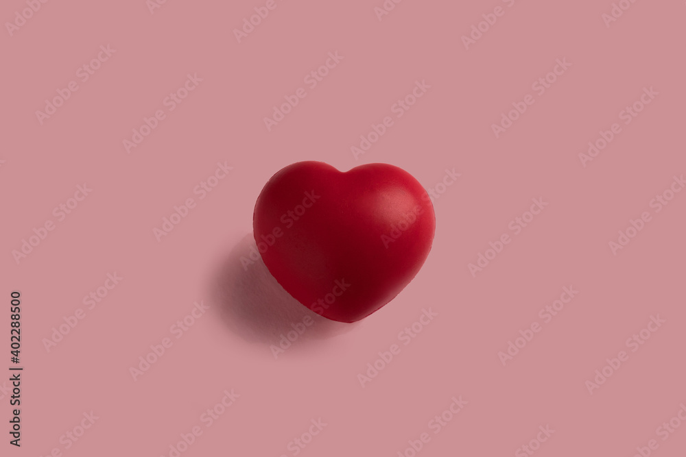 Isolated red heart on a pink background