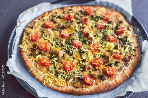 plant-based food, vegan flatbread pizza with cherry tomatoes and dairy-free cheese