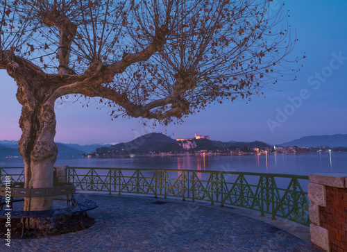 Wallpaper Mural panoramic bench on the lakefront overlooking Angera castle at sunset.panoramic balcony on lake Maggiore.Arona, Piedmont, Italian lakes, Italy. Torontodigital.ca