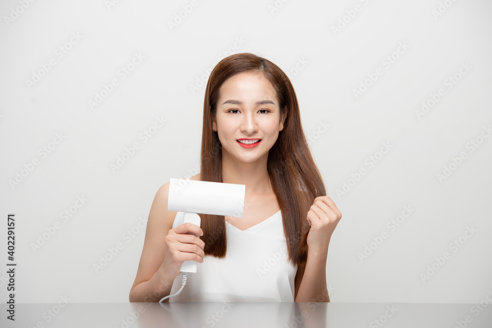 Attractive beautiful Asian woman blowing the wind by hair dryer Attractive beautiful Asian woman blowing the wind by hair dryer