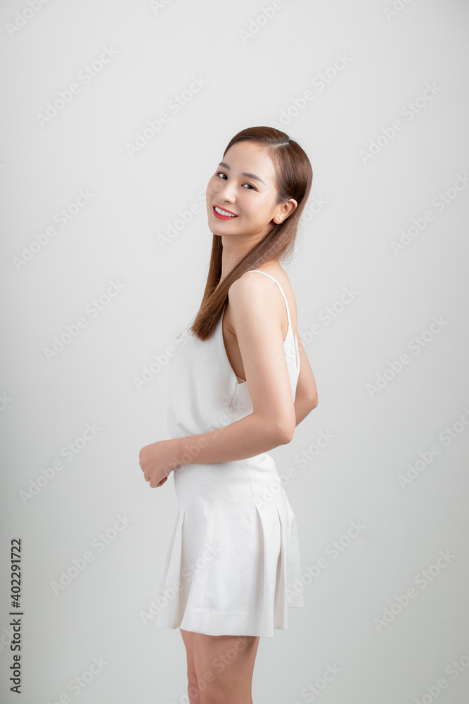 Portrait of an excited asian businesswoman jumping and looking at camera isolated over white background Portrait of an excited asian businesswoman jumping and looking at camera isolated over white background