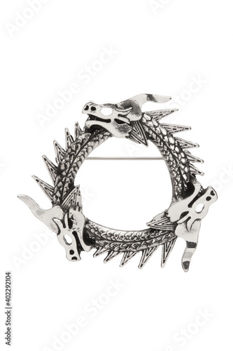 Detail shot of silver brooch made as triple Uroboros - three dragons biting each other's tails Fototapete