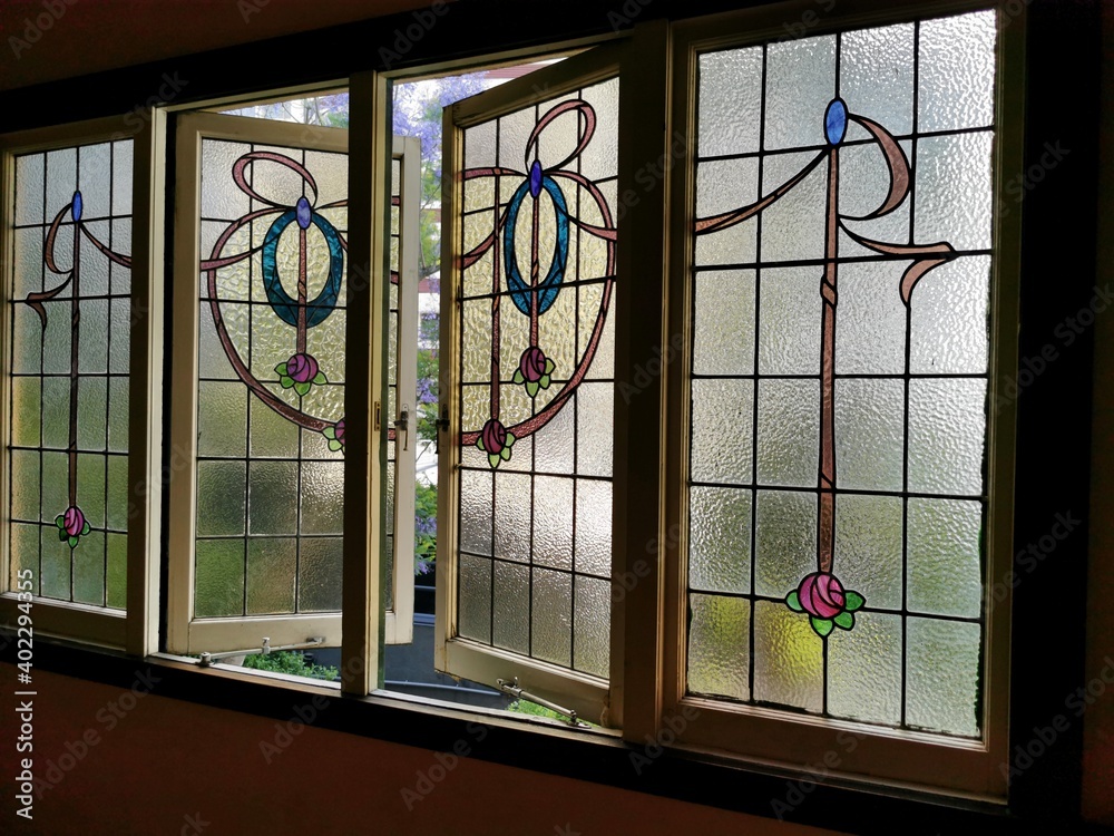 View of a stained glass window in an old house View of a stained glass window in an old house