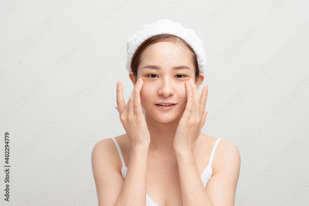 Beautiful woman doing facial massage, touching her face. Beautiful woman doing facial massage, touching her face.
