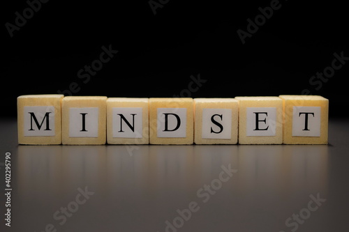 The word MINDSET written on wooden cubes isolated on a black background