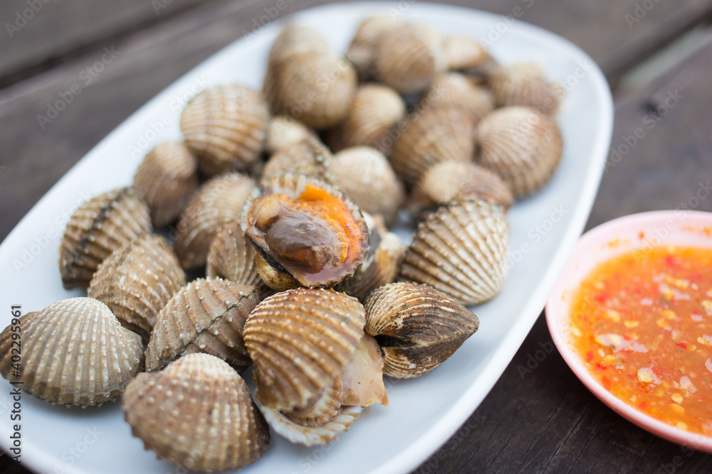 Boiled scallop is served with spicy sauce as a sea food in Thai style.
