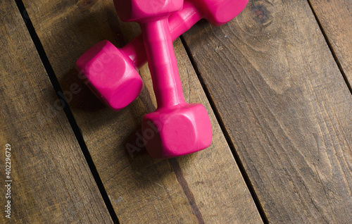 magenta weights on natural wood for exercise