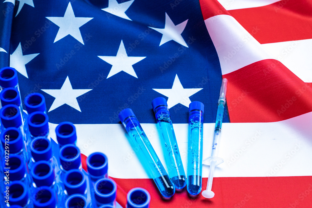 Vaccine usa isolated. Medical syringe with needle for protection flu virus and coronavirus. Covid immunization on american flag background. Concept fight against virus covid-19.