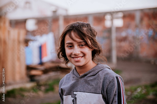 A portrait of a beautiful smiling gypsy woman in a Roma settlement looking at the camera