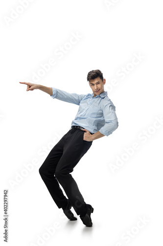 Dance king. Happy young man dancing in casual clothes or suit, remaking legendary moves and dances of celebrity from culture history. Isolated on white. Action, motion, fame concept. Creative