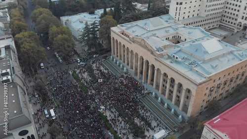 1st november, 2020. Tbilisi.Georgia.Ascending front Aerial view down to crowds of perople gathered protesting in front of parliament building.Post parliament election protests in caucasus. photo