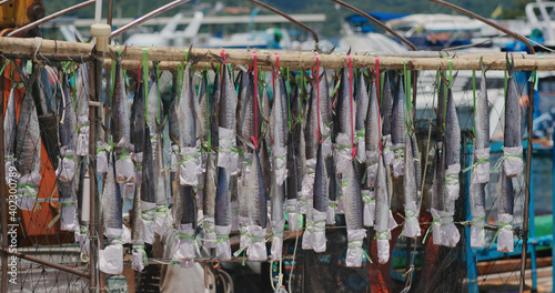 Sai Kung, Hong Kong 14 August 2020: salted fish hanging on the boat © leungchopan