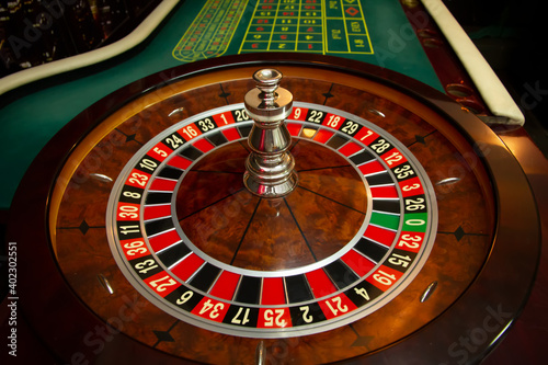 Casino. Drum with numbers. Poker table and card inra