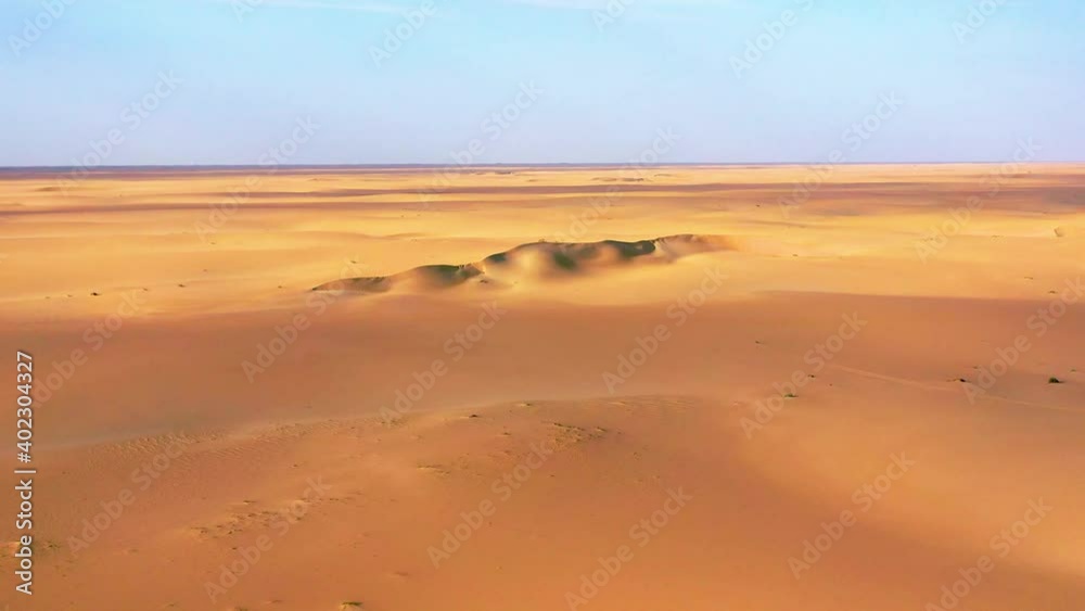 Aerial view towards a large sandbank, surrounded by wild, hot desert - dolly, drone shot Aerial view towards a large sandbank, surrounded by wild, hot desert - dolly, drone shot