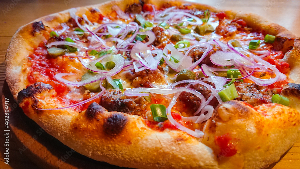 Delicious and appetizing pizza photographed a close up Delicious and appetizing pizza photographed a close up