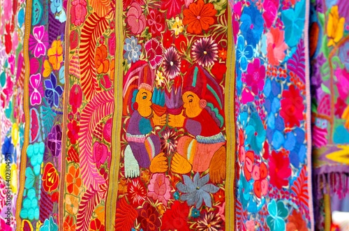 Colorful market with beautiful and unuque handicraft fabric patterns available in Otavalo, Ecuador 