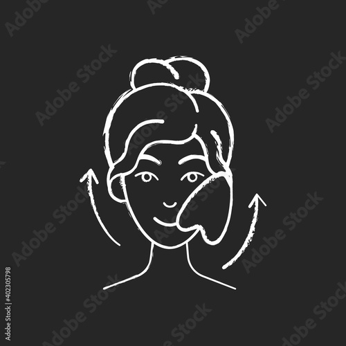 Gua sha stone chalk white icon on black background. Removing puffiness under eyes. Angled stone. Scraping skin on face. Promoting blood flow. Chinese tool. Isolated vector chalkboard illustration