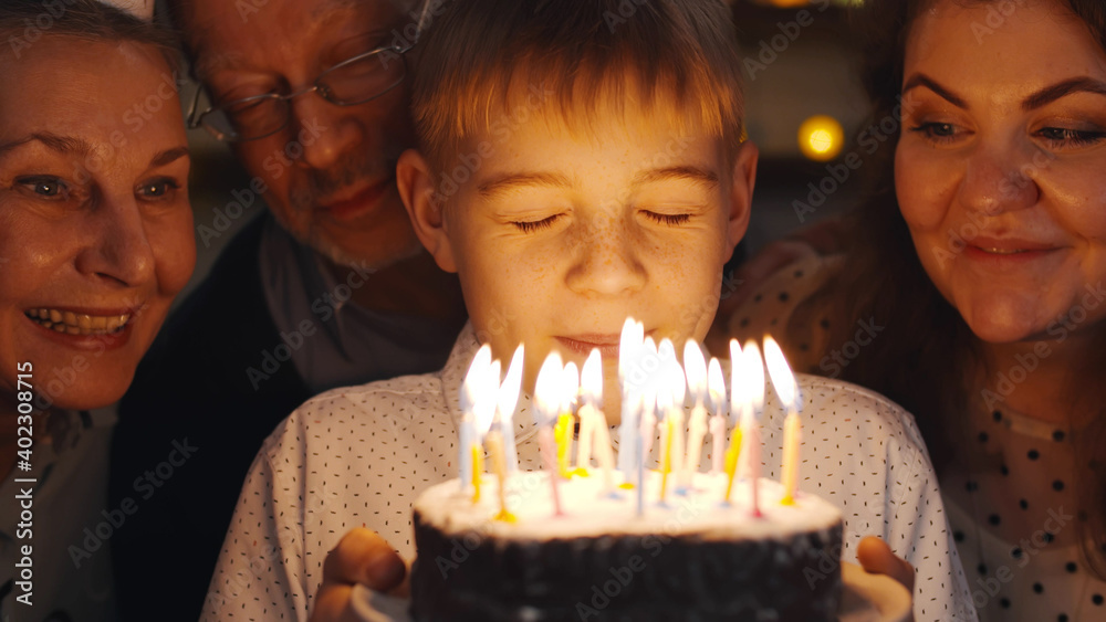 Multi-generation family celebrating birthday of preteen boy Multi-generation family celebrating birthday of preteen boy