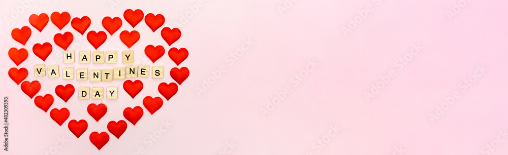 Banner.The word Happy Valentines Day. Love on wooden blocks. Theme of love. Wooden letter blocks. Loving, positive emotions. Wooden cubes with the word. An exclusive relationship.