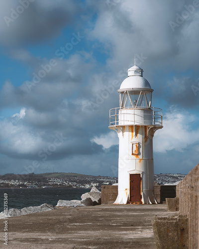 White lighthouse on the pier in Brixham on the Devon coastline
