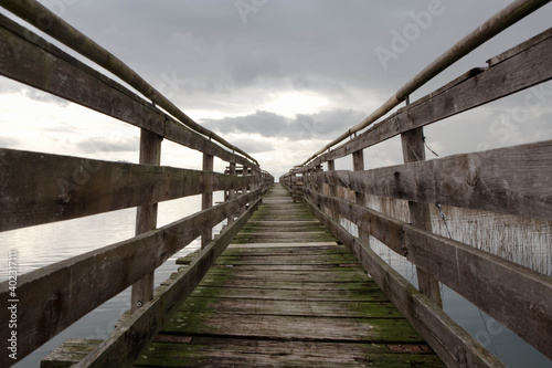 Old wooden pier  in a cloudy day  Trasimeno Lake  naturalistic oasis of   La valle    San Savino  municipality of Magione   Umbria  Italy