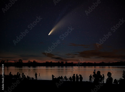 Comet Neowise comet C/2020 F3 (NEOWISE) and crowd of people  silhouetted by the Ottawa river watching and photographing the comet photo