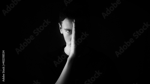Serious man in black background