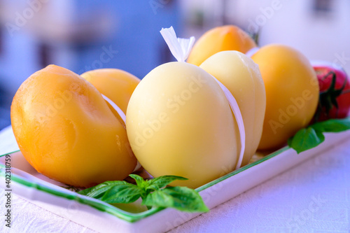 Cheese collection, Italian cheese scamorza made from cow milk in South Italy, white and yellow smoked.