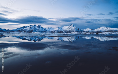 Calm crystal bay surrounded with snowy mountains © BullRun