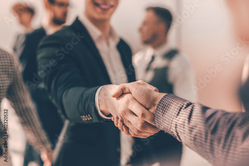 close up. young casual business people shaking hands with each photo