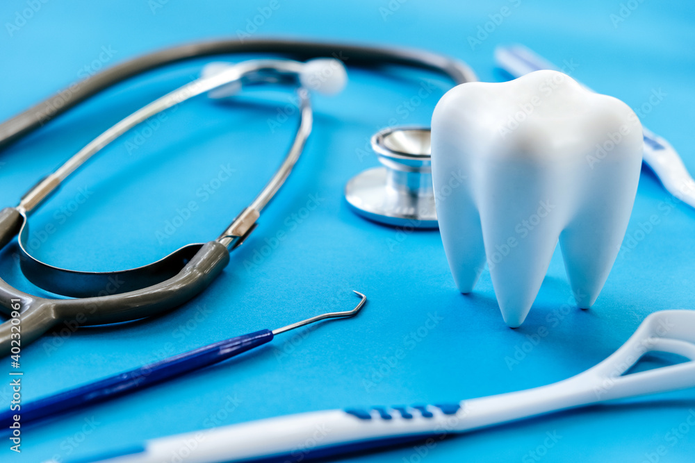 Dental model and dental equipment on blue background, concept image of