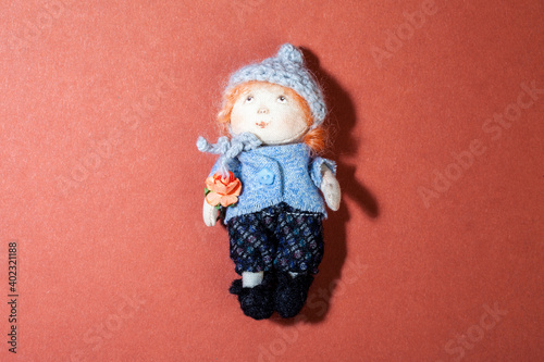 Girl rag doll isolated on red background photo