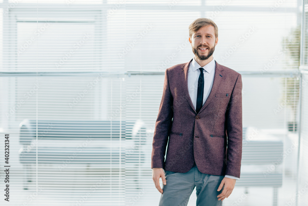 portrait of a confident business man on an office background. portrait of a confident business man on an office background.