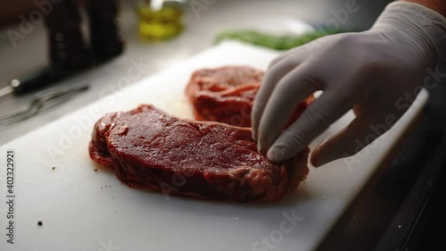 Cooking beef steak at home, Beef fillet on the Cut Board, Juicy steak with grilling stripes, Chef salt grilled meat at stone cutting board