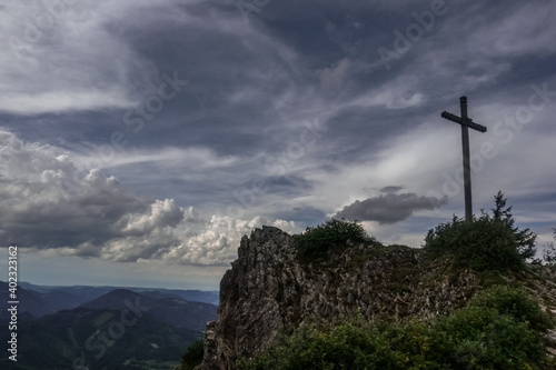 summit cross on a mountain with beautiful clouds on the sky