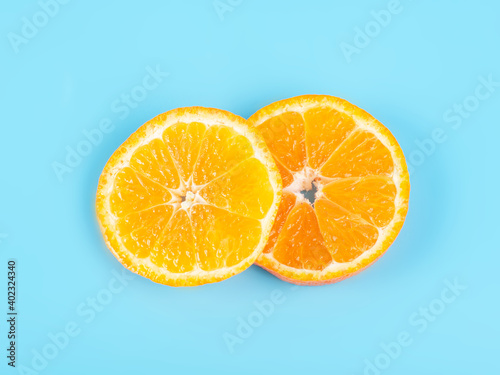 Orange tangerine slice on blue background