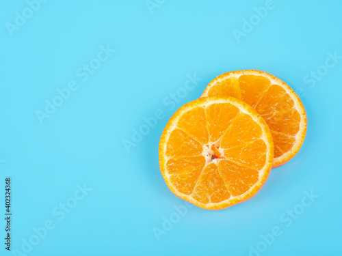 Orange tangerine slice on blue background