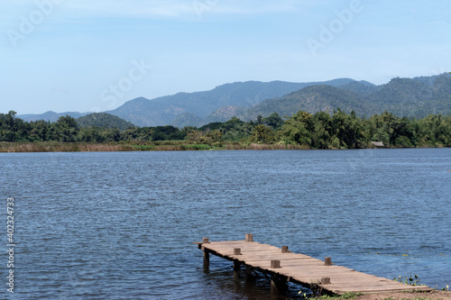 Landscape of the mountains over the river in the national park near the dam over the blue sky clouds with natural relax feeling in the holiday, travel and vacation concept © pploylp