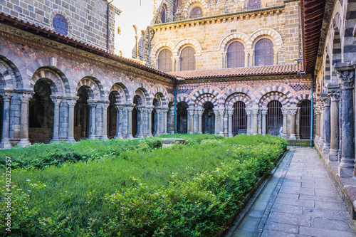 The 12th century cloister of Notre Dame cathedral in le Puy en Velay  Auvergne  France  is a medieval wonder with its amazing romanesque and colorful architecture