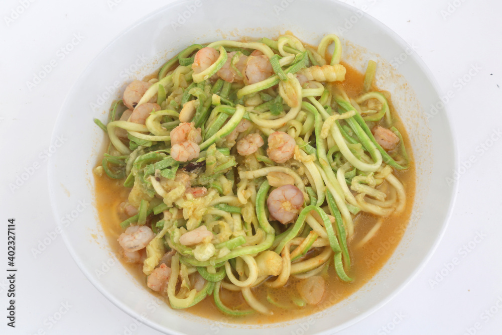 fresh and raw zucchini spaguetti with prawns as imitation of italian pasta for vegetarian food