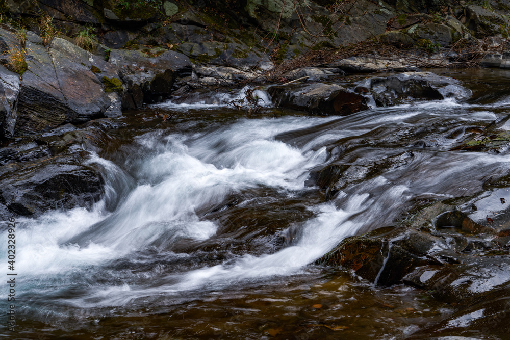 Close-up of the slow water flow of a mountain stream Close-up of the slow water flow of a mountain stream