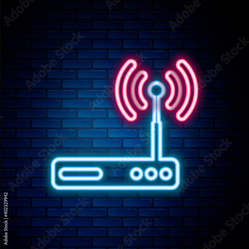 Glowing neon line Router and wi-fi signal symbol icon isolated on brick wall background. Wireless ethernet modem router. Computer technology internet. Colorful outline concept. Vector.