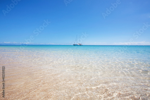 Michaelmas and Upolu Cays National Park view from the paradisiac beach, a boat in the distance, Cairsn, Queensland, Australia.