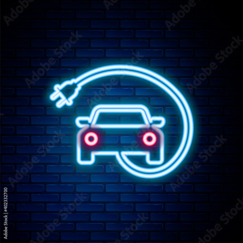 Glowing neon line Electric car and electrical cable plug charging icon isolated on brick wall background. Renewable eco technologies. Colorful outline concept. Vector.