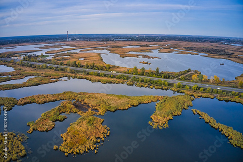 The road passes through the Samarskie Plavni picturesque Ukraine in the evening light