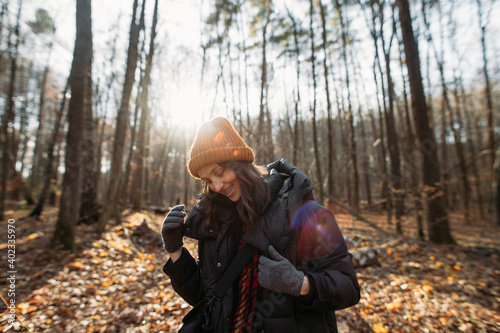 happy young woman in autumn winter forest