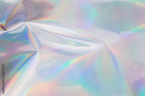 Rainbow halographic wrinkled foil background. Abstract pastel color background. photo